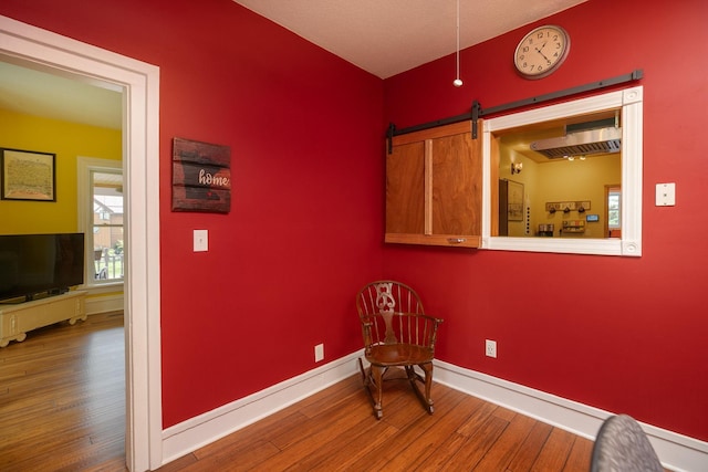 10706 65th Ave SE, Stewartville, MN 55976 - unfurnished room featuring hardwood / wood-style flooring and a barn door