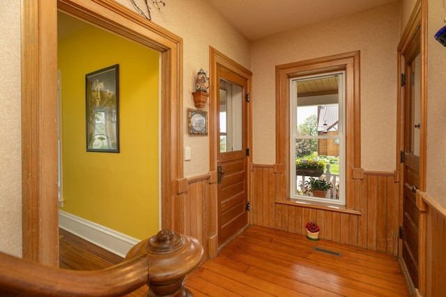 10706 65th Ave SE, Stewartville, MN 55976 - hall featuring a wainscoted wall, hardwood / wood-style flooring, and wood walls