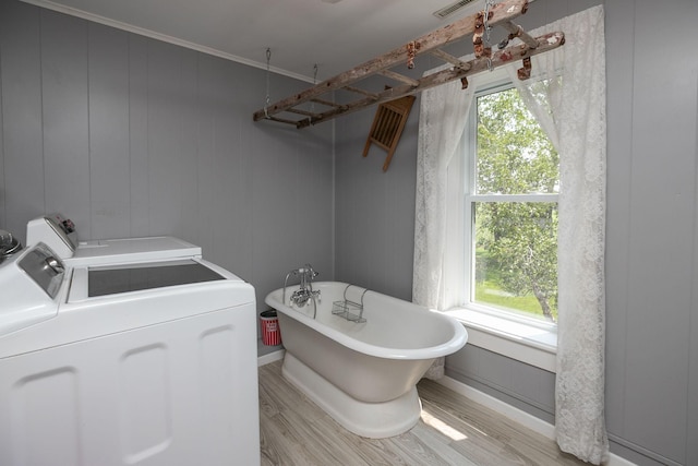 10706 65th Ave SE, Stewartville, MN 55976 - laundry room with plenty of natural light, wood finished floors, and washing machine and dryer
