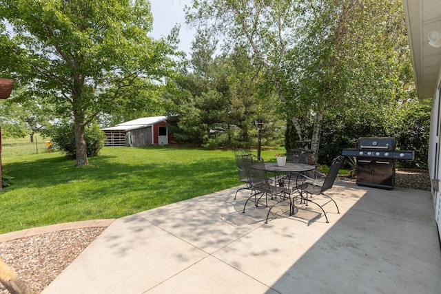10706 65th Ave SE, Stewartville, MN 55976 - view of patio / terrace with a grill, outdoor dining space, and an outbuilding