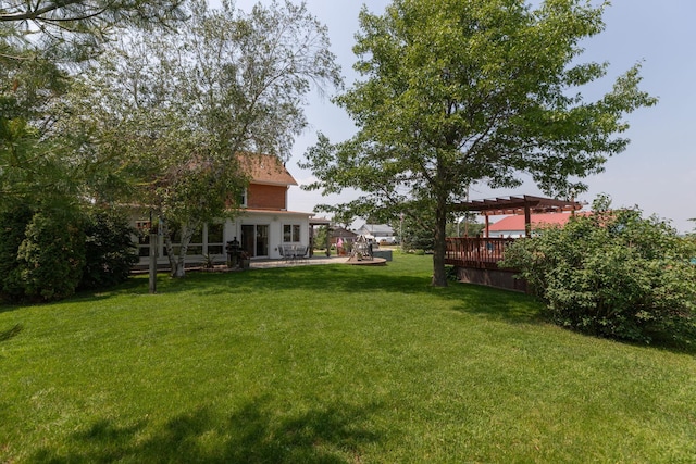 10706 65th Ave SE, Stewartville, MN 55976 - view of green lawn with a deck and a patio