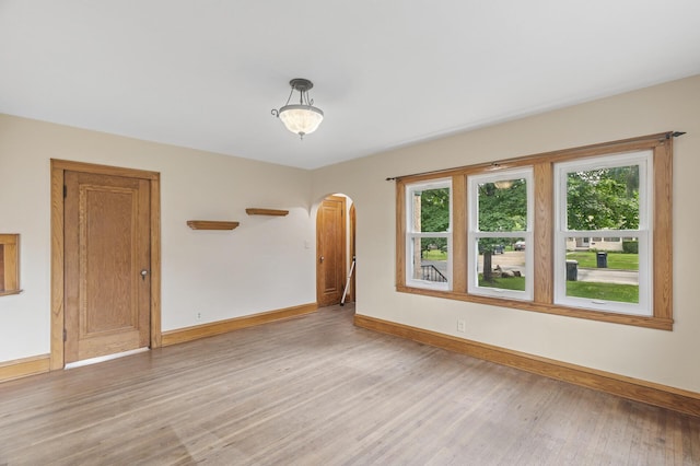 613 Oak St, Farmington, MN 55024 - unfurnished room featuring arched walkways and light wood-style floors
