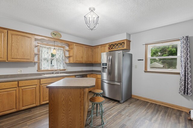 613 Oak St, Farmington, MN 55024 - kitchen featuring stainless steel fridge with ice dispenser, open shelves, dark wood-type flooring, a textured ceiling, and a kitchen breakfast bar
