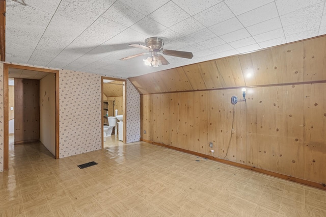 613 Oak St, Farmington, MN 55024 - unfurnished room with ceiling fan, light floors, and wood walls