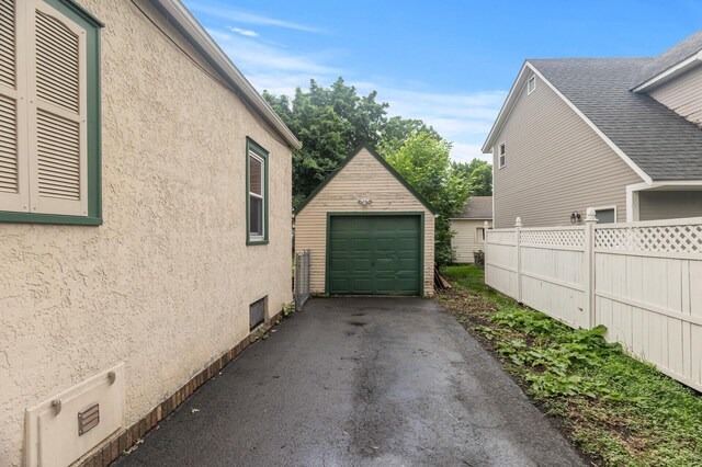 613 Oak St, Farmington, MN 55024 - view of side of property with an outdoor structure, stucco siding, a garage, and driveway
