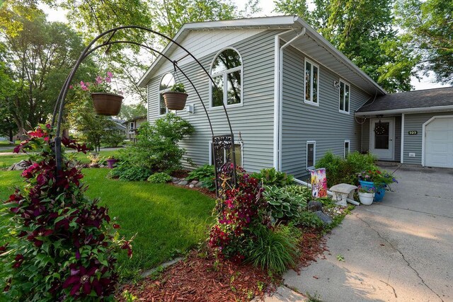 505 1st Ave, Raymond, MN 56282 - view of home's exterior with an attached garage, driveway, and a lawn