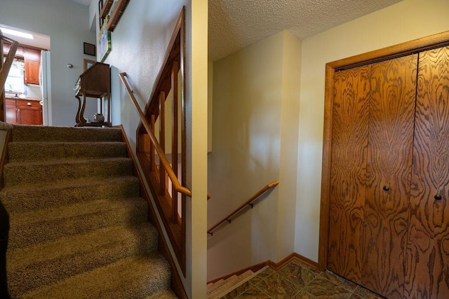 505 1st Ave, Raymond, MN 56282 - stairs with a textured ceiling and baseboards