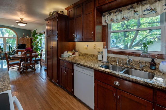 505 1st Ave, Raymond, MN 56282 - kitchen with dishwasher, light wood-style flooring, and light stone countertops