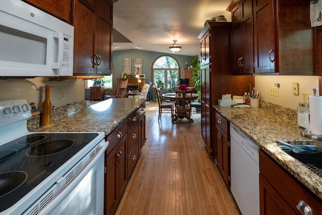 505 1st Ave, Raymond, MN 56282 - kitchen featuring white appliances, light wood-style flooring, and light stone counters