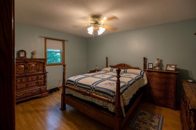505 1st Ave, Raymond, MN 56282 - bedroom with wood finished floors, a textured ceiling, and a ceiling fan