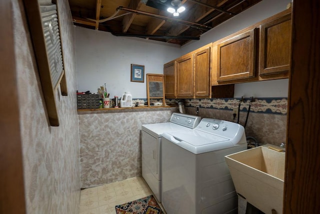 505 1st Ave, Raymond, MN 56282 - laundry area featuring washer and dryer, cabinet space, and light flooring