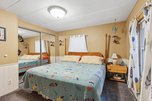 22325 519th Ln, Workman Twp, MN 55760 - bedroom with carpet flooring, a closet, and a wainscoted wall