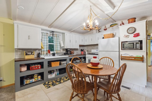 22325 519th Ln, Workman Twp, MN 55760 - kitchen with white appliances, a chandelier, vaulted ceiling, decorative backsplash, and white cabinetry
