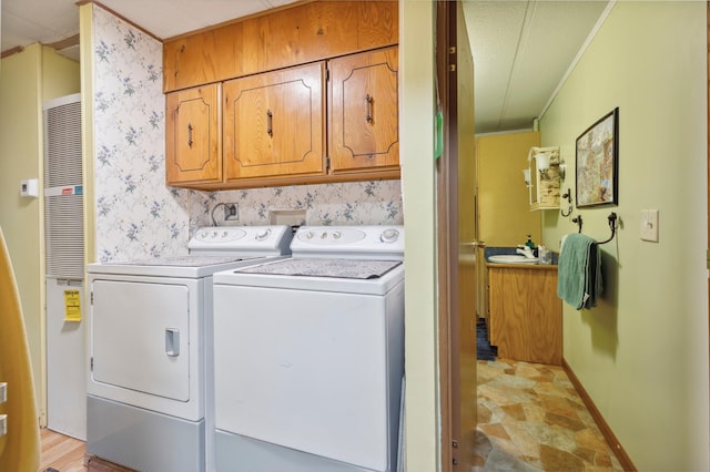 22325 519th Ln, Workman Twp, MN 55760 - laundry room with cabinet space, washer and clothes dryer, ornamental molding, and a heating unit