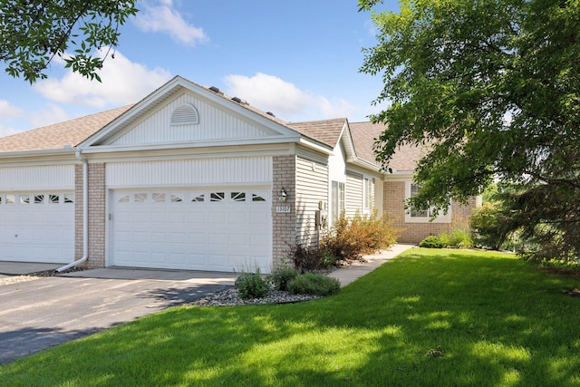 13107 Falcons Way, Savage, MN 55378 - view of front of house with brick siding, concrete driveway, roof with shingles, a front yard, and a garage