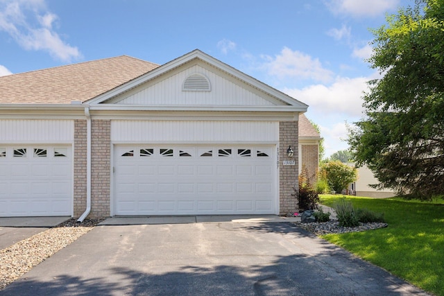 13107 Falcons Way, Savage, MN 55378 - view of front of home with brick siding, driveway, roof with shingles, and an attached garage