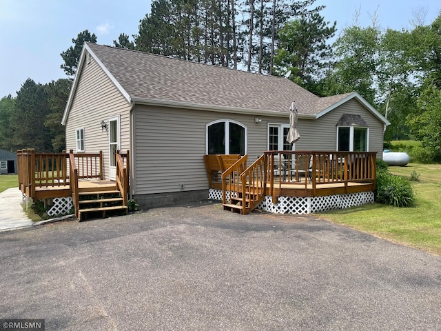 21507 County Road 560, Goodland Twp, MN 55742 - view of front facade featuring a deck and roof with shingles