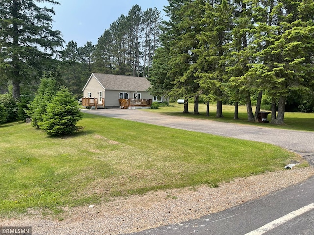 21507 County Road 560, Goodland Twp, MN 55742 - view of front of home with driveway, a deck, and a front yard