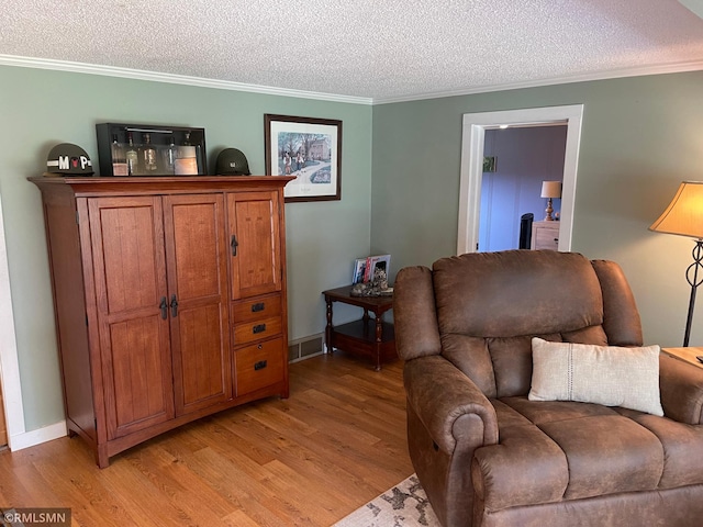 21507 County Road 560, Goodland Twp, MN 55742 - living room with a textured ceiling, light wood-type flooring, and ornamental molding
