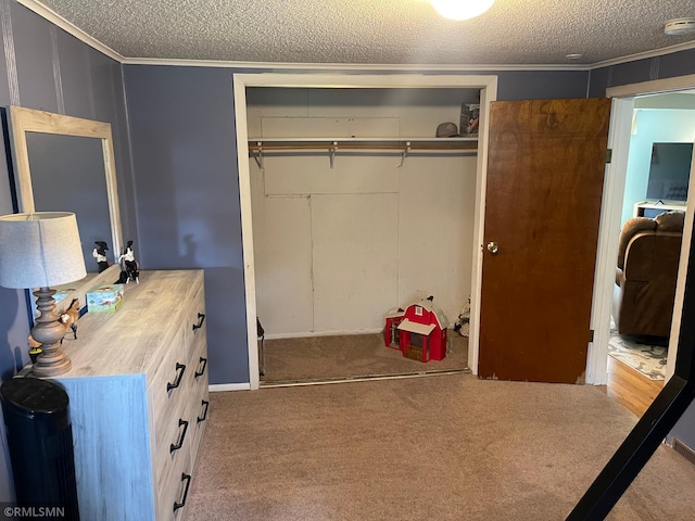 21507 County Road 560, Goodland Twp, MN 55742 - bedroom with a closet, a textured ceiling, carpet floors, and ornamental molding