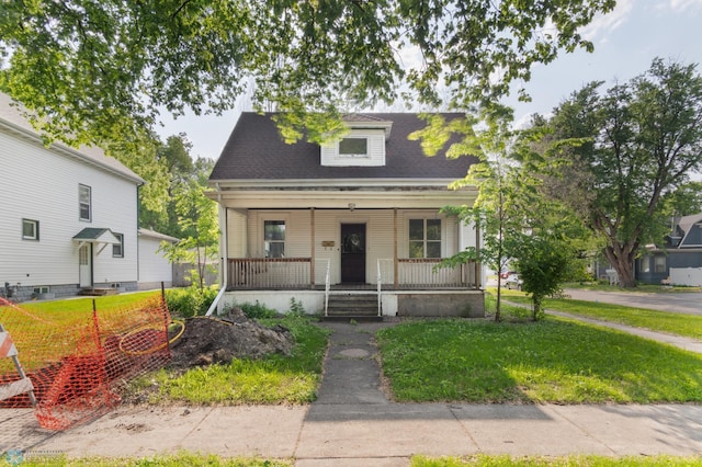824 9th St N, Fargo, ND 58102 - view of front of house featuring covered porch, a front lawn, and a shingled roof