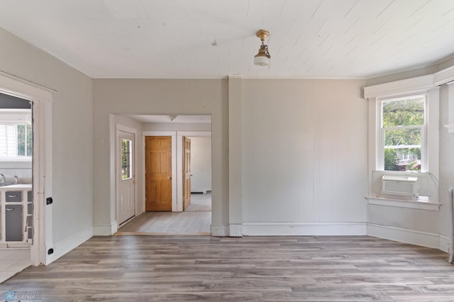 824 9th St N, Fargo, ND 58102 - unfurnished room featuring wood finished floors and cooling unit