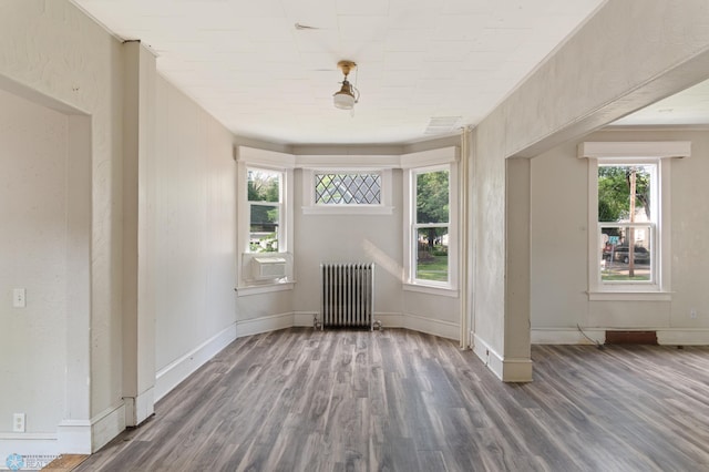 824 9th St N, Fargo, ND 58102 - spare room featuring radiator heating unit, wood finished floors, and cooling unit