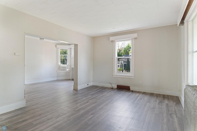 824 9th St N, Fargo, ND 58102 - unfurnished room with healthy amount of natural light, wood finished floors, and cooling unit