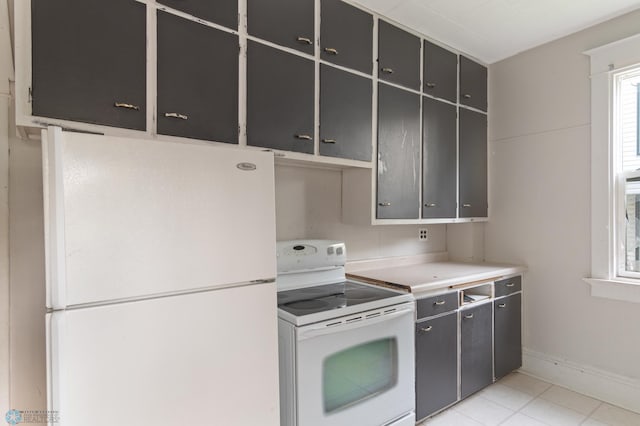 824 9th St N, Fargo, ND 58102 - kitchen with white appliances, gray cabinets, light countertops, and light tile patterned flooring