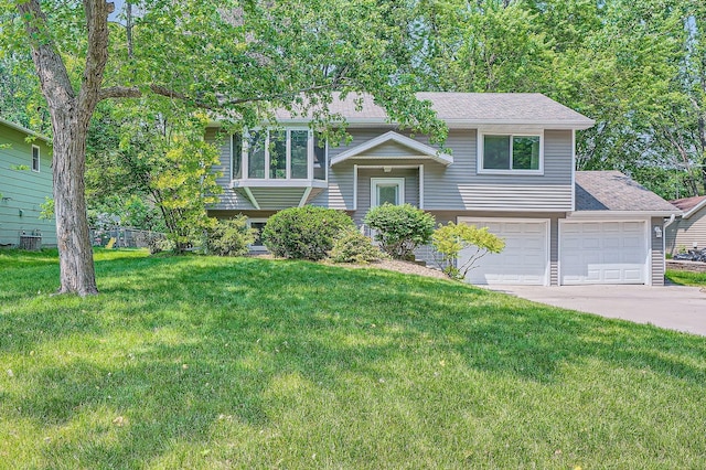 5774 213th St N, Forest Lake, MN 55025 - split foyer home with a front yard, driveway, roof with shingles, and an attached garage