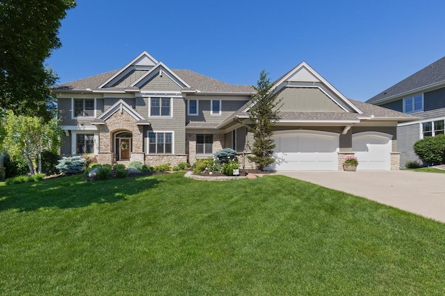 10701 Sonoma Rdg, Eden Prairie, MN 55347 - craftsman-style home featuring stone siding, concrete driveway, a garage, and a front lawn