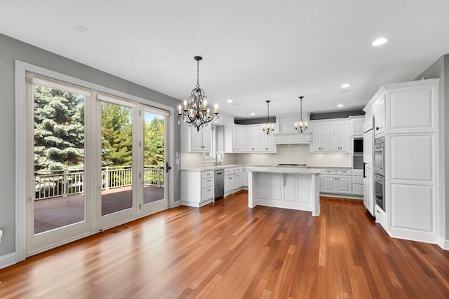 10701 Sonoma Rdg, Eden Prairie, MN 55347 - kitchen with dishwasher, a chandelier, light countertops, stovetop, and decorative backsplash