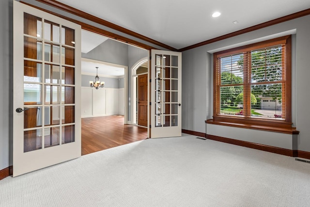 10701 Sonoma Rdg, Eden Prairie, MN 55347 - spare room featuring french doors, crown molding, carpet floors, a chandelier, and recessed lighting