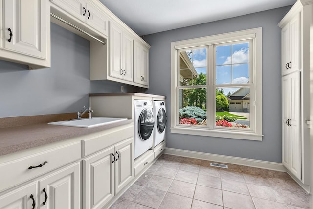 10701 Sonoma Rdg, Eden Prairie, MN 55347 - laundry area with washer and dryer, cabinet space, and light tile patterned floors