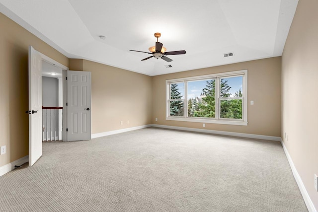 10701 Sonoma Rdg, Eden Prairie, MN 55347 - spare room featuring light colored carpet, a raised ceiling, and a ceiling fan