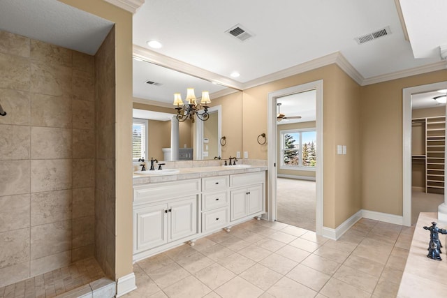 10701 Sonoma Rdg, Eden Prairie, MN 55347 - bathroom featuring crown molding, double vanity, tile patterned floors, a ceiling fan, and a chandelier