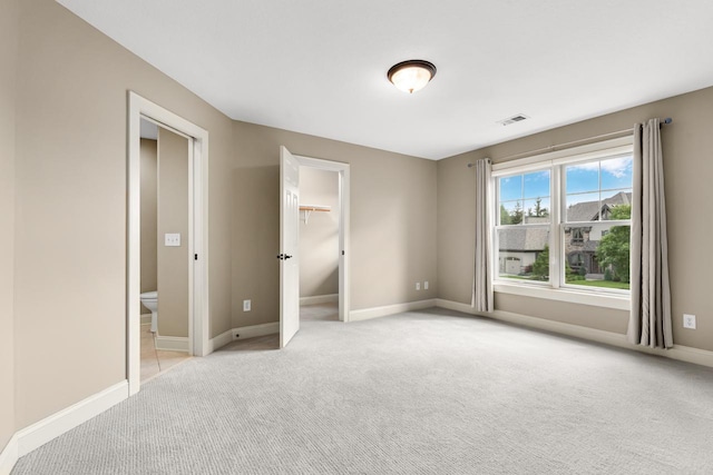 10701 Sonoma Rdg, Eden Prairie, MN 55347 - unfurnished bedroom featuring light carpet, a spacious closet, and a closet