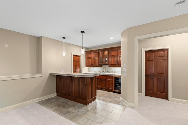 10701 Sonoma Rdg, Eden Prairie, MN 55347 - kitchen featuring beverage cooler, light countertops, a kitchen bar, a peninsula, and tasteful backsplash