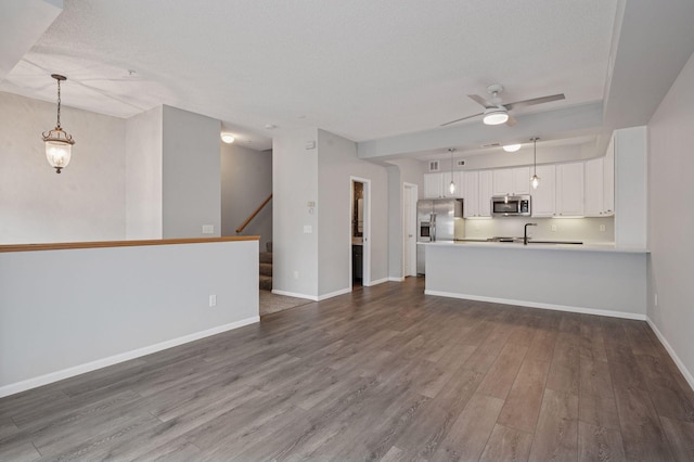 7601 Garfield Ave Unit 103, Richfield, MN 55423 - unfurnished living room featuring a ceiling fan, dark wood finished floors, stairs, and a textured ceiling