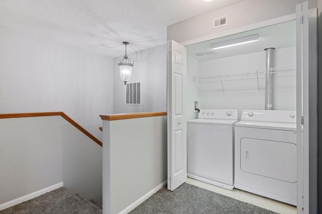7601 Garfield Ave Unit 103, Richfield, MN 55423 - washroom with washer and clothes dryer, a textured ceiling, and light carpet