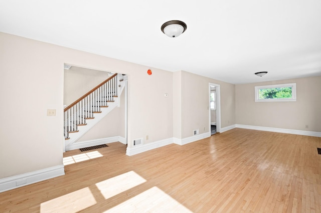 808 6th Ave E, Duluth, MN 55805 - empty room with wood finished floors and stairway