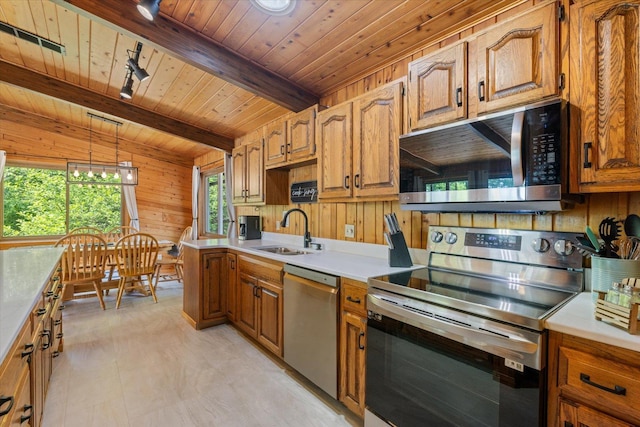 36388 Wabana Rd, Wabana Twp, MN 55744 - kitchen featuring stainless steel appliances, a wooden ceiling with exposed beams, wood walls, light countertops, and brown cabinets