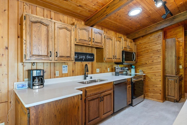 36388 Wabana Rd, Wabana Twp, MN 55744 - kitchen with appliances with stainless steel finishes, wood walls, wooden ceiling, light countertops, and brown cabinets