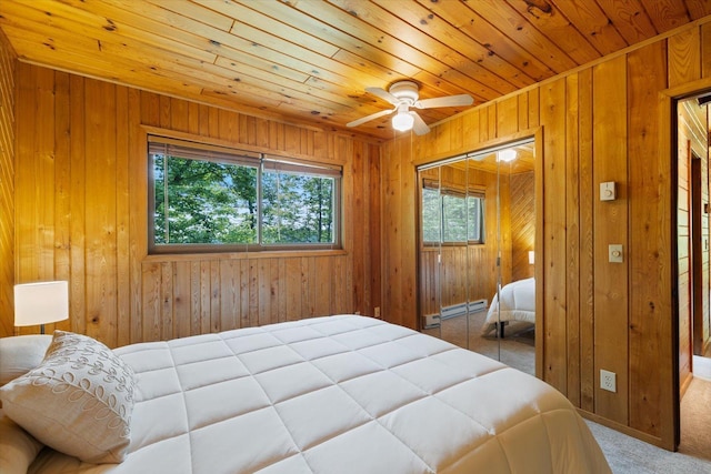 36388 Wabana Rd, Wabana Twp, MN 55744 - bedroom with carpet flooring, a baseboard radiator, wooden walls, wooden ceiling, and a closet