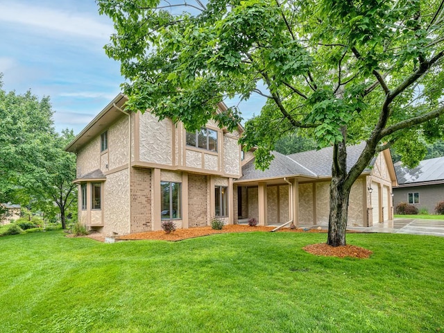 4125 Bridgewater Cir, Vadnais Heights, MN 55127 - tudor-style house featuring a front yard, concrete driveway, and an attached garage