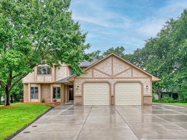 4125 Bridgewater Cir, Vadnais Heights, MN 55127 - view of front facade with concrete driveway, an attached garage, a front lawn, and brick siding