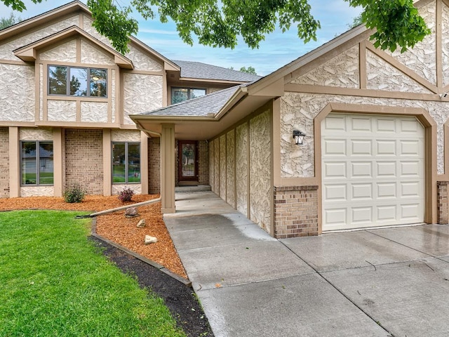 4125 Bridgewater Cir, Vadnais Heights, MN 55127 - view of front of home with stucco siding, a front yard, driveway, and brick siding
