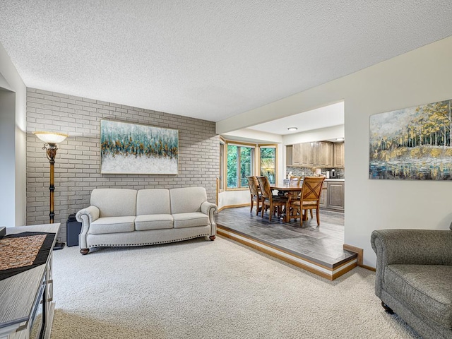 4125 Bridgewater Cir, Vadnais Heights, MN 55127 - living area with brick wall, carpet, and a textured ceiling