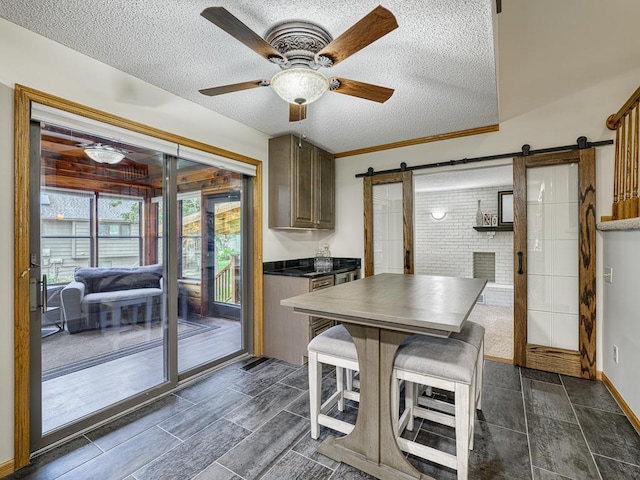 4125 Bridgewater Cir, Vadnais Heights, MN 55127 - dining area with a barn door, a textured ceiling, and ceiling fan