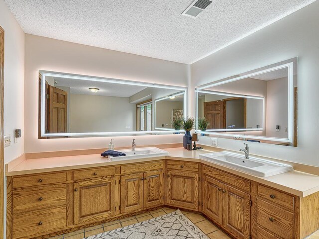 4125 Bridgewater Cir, Vadnais Heights, MN 55127 - full bathroom with double vanity, a textured ceiling, and tile patterned flooring